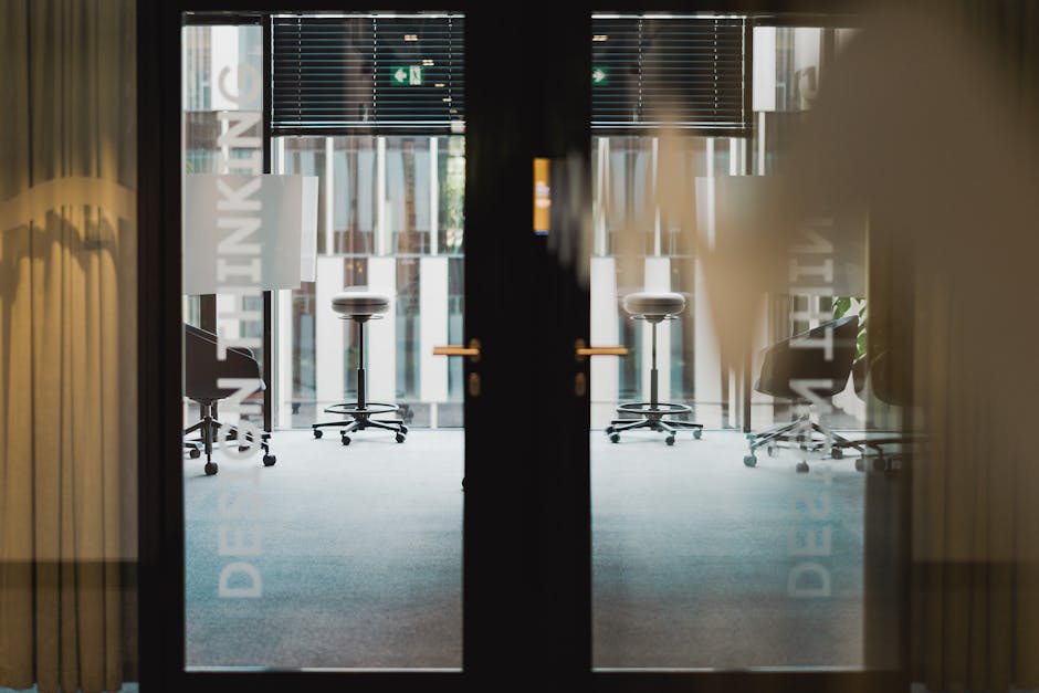 Contemporary office entrance showcasing an interior design studio with ergonomic furniture.